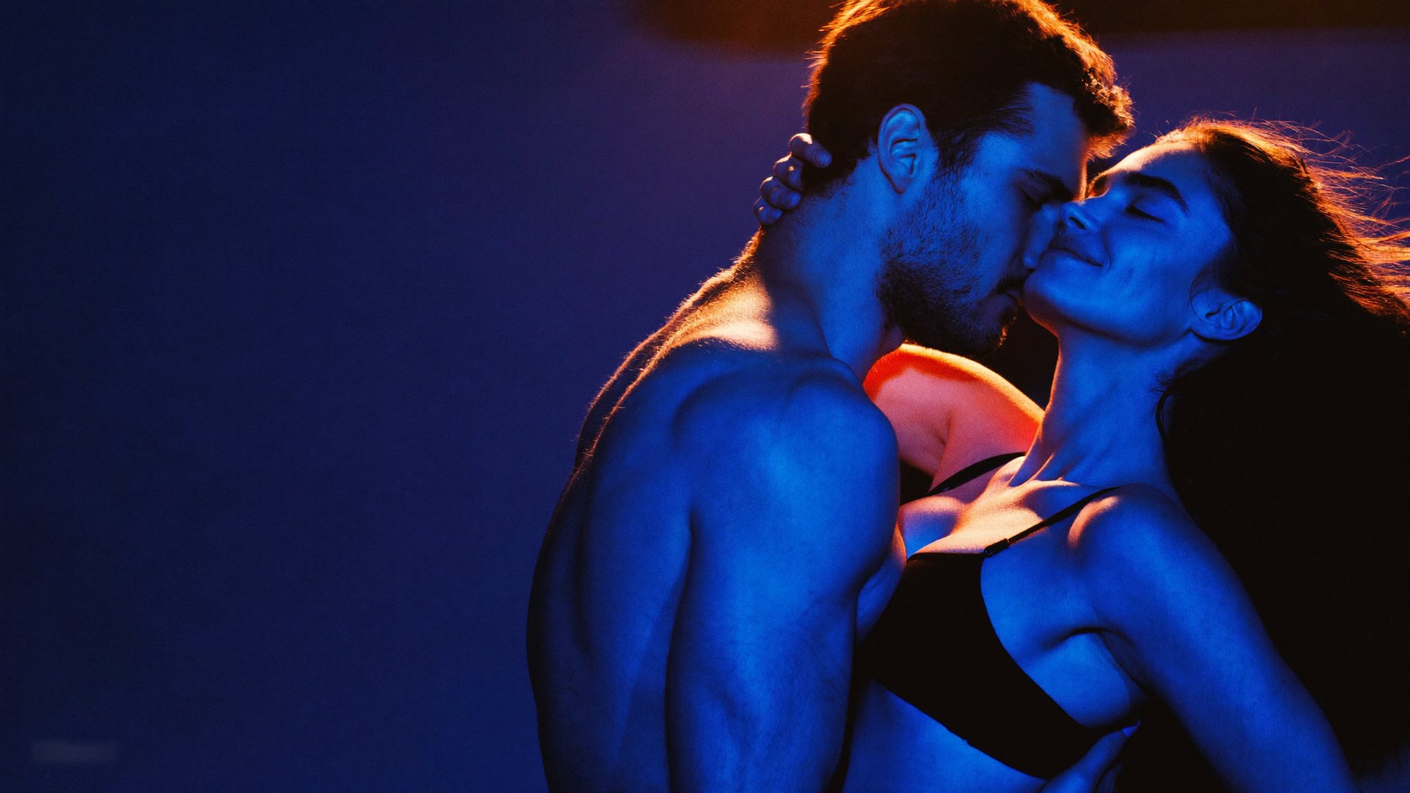 A couple embracing under blue light