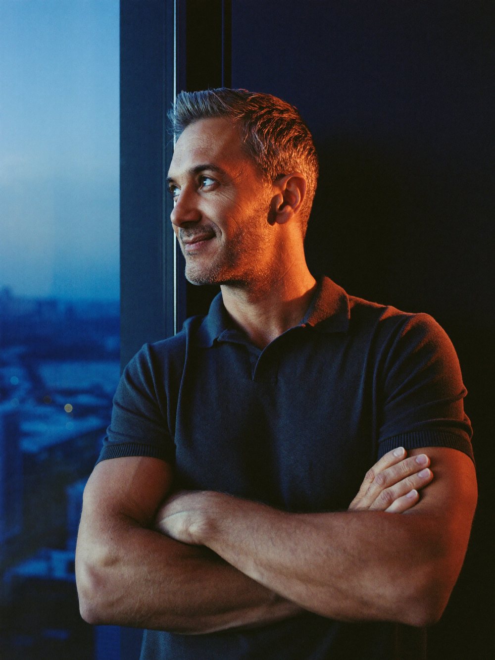 A confident man in a dark room at night